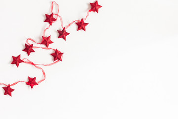 Christmas composition. Christmas red garland on white background. Flat lay, top view, copy space