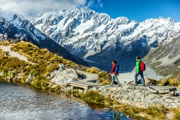 Washable wall murals Aoraki/Mount Cook Hiking travel nature hikers in New Zealand mountains. Mount Cook landscape. Couple people walking on Sealy Tarns hike trail route towards Mueller Hut, famous tourist attraction.