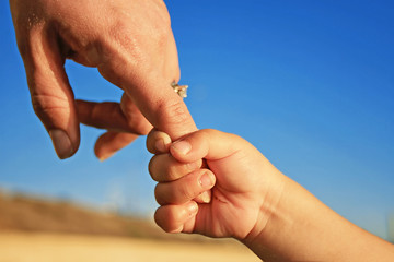 Toddler Gripping Mom's Finger
