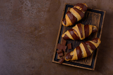 Сhocolate croissant and chocolatier on table