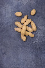 Unpeeled  peanuts on stone background