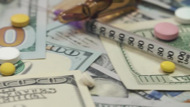 Pills, drugs, cocaine, syringe on dollar bank notes 