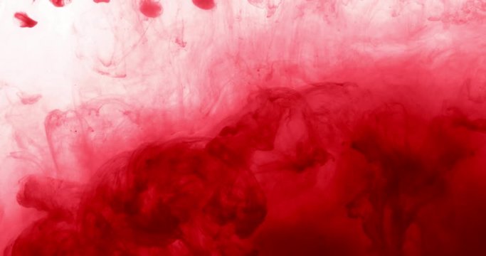 Red Ink Color in Water Creating Liquid Art Shape