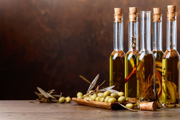 Green olives and bottles of olive oil .