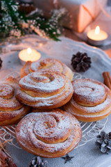 Kanelbullar (Swedish cinnamon rolls) in Christmas decorations, selective focus
