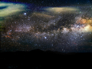 silhouette mountain and blur milky way galaxy in night