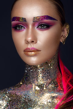 Beautiful girl with creative glitter makeup with sparkles, unusual eyebrows. Beauty is an art face. Photo taken in the studio.