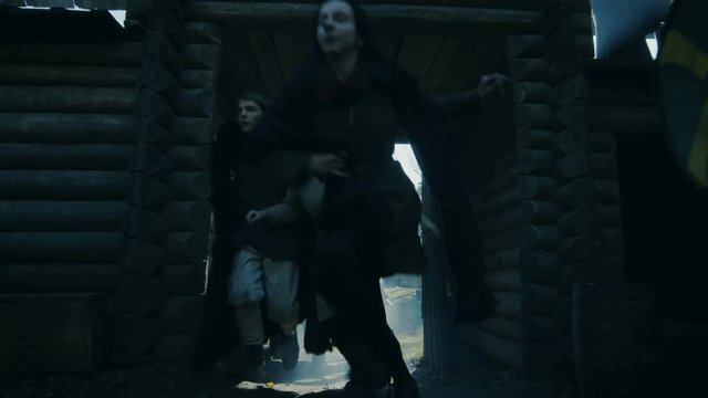 Medieval Battle, Guards Standing in the Wooden Fortress Gates Defend Hillfort From Viking Attack. Medieval Reenactment. Shot on RED EPIC-W 8K Helium Cinema Camera.