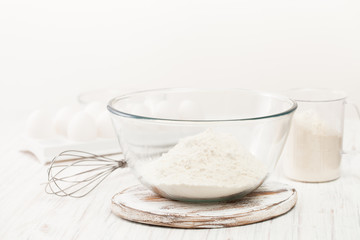 Flour in a Cup on a white table in the kitchen