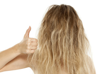 Blonde with messy hair, showing thumbs up - obrazy, fototapety, plakaty
