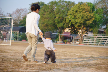 Asian mother teach her son to walk