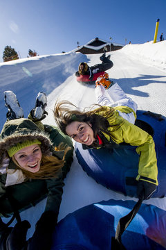 Young women enjoying snowtubing, Kreischberg, Styria, Austria