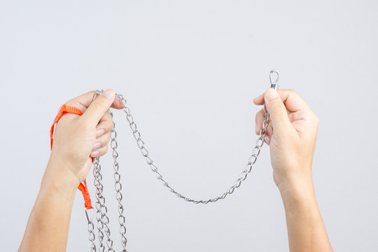 Hand Holding A Dog Choke Chain Training Collar Made Of Metal