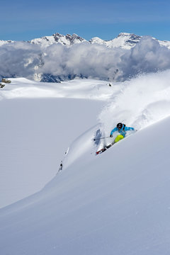 Skier turning in front of a scenic mountain range, Verbier, Switzerland