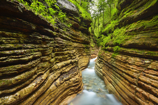Stream flowing through red canyon, Salzkammergut, Salzburg, Austria