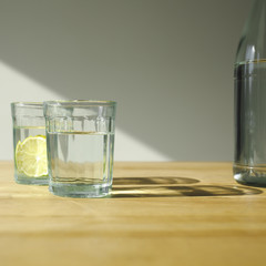 glasses with detox water with limes on wooden table