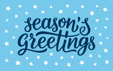 Seasons greetings calligraphy lettering text on blue background with white doodle stars. Retro greeting card for Christmas and New Year holidays. Vector background © aerial333