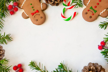 Christmas fir tree and gingerbread cookies on white board