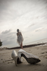 Bride walking on the beach