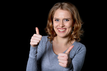 young woman showing thumbs up 