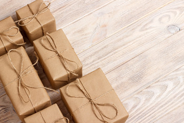 Gift wrapping composition. homemade wrapped present boxes on wooden background. above view copy space