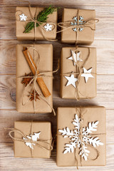 Christmas background with homemade wrapped christmas present and decoration on wooden surface