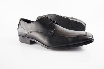 Male black leather shoe on white background, isolated product, footwear.