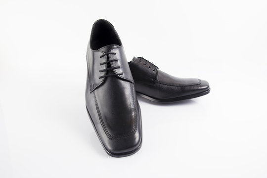 Male black leather shoe on white background, isolated product, footwear.