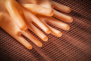 Insulating gloves on dielectric rubber mat