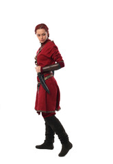 portrait of a red haired girl wearing medieval warrior outfit, studio background.