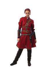 portrait of a red haired girl wearing medieval warrior outfit, studio background.