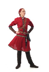 portrait of a red haired girl wearing medieval warrior outfit, studio background.