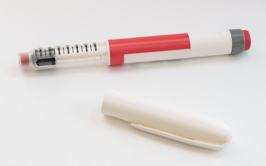 Diabetes pen injection needle on white background. Selective focus.