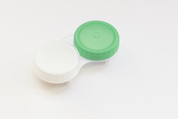 Contact lens case on white background. Selective focus.