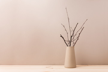 Ceramic vase with decorative branches - obrazy, fototapety, plakaty
