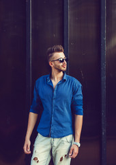 Obraz premium handsome young man standing near wall