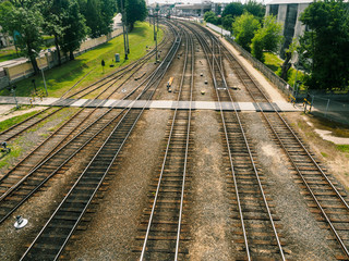 Fototapeta na wymiar Railway Tracks And Pedestrian Railroad Crossing In City