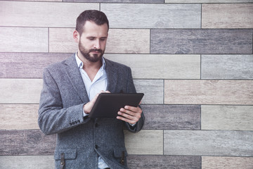 handsome businessman holding digital tablet touching with finger