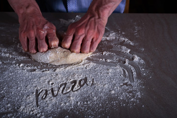 Man chef making dough for pizza