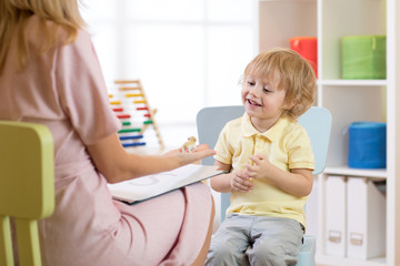 Child psychologist working with kid boy