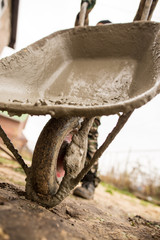 worker pours concrete mortar on a construction site