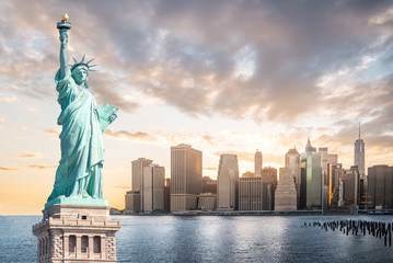 The Statue of Liberty with Lower Manhattan background in the evening at sunset, Landmarks of New...