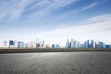 Obraz premium empty asphalt road with modern cityscape