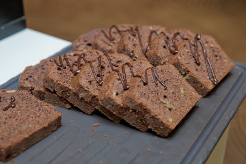 Sliced chocolate cake . Sliced homemade brownies tower. Sweet and moist of chocolate dessert. Pile...