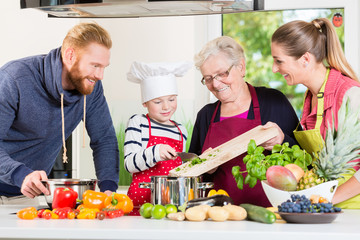 Family cooking in multigenerational household with son, mother, father and grandfather