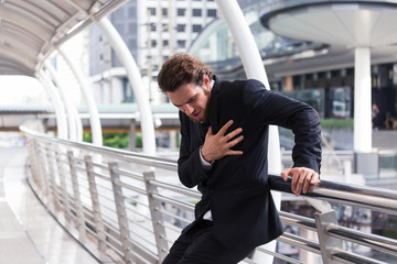 Businessman having heart attack in the walkway at office,Emergency Heart attack concept