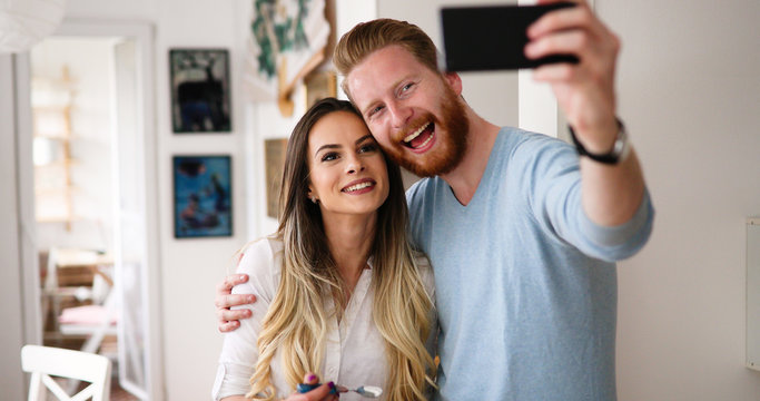 Cheerful couple taking a humorous selfie
