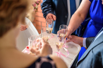 Close-up of human hands holding glasses of champagne