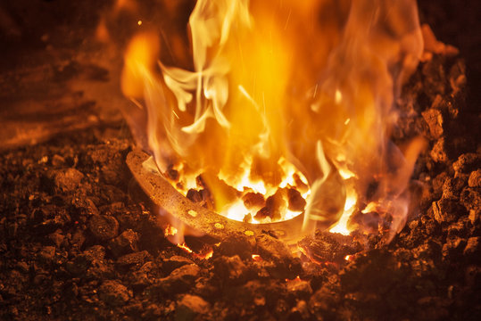 Horseshoe glowing in the fire of a blacksmiths workshop, Vellberg, Schwaebisch Hall province, Baden-Wuerttemberg, Germany