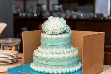Green wedding cake decorated with sugar white flowers